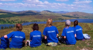 A group of volunteers rest while walking the West Highland Way in Scotland