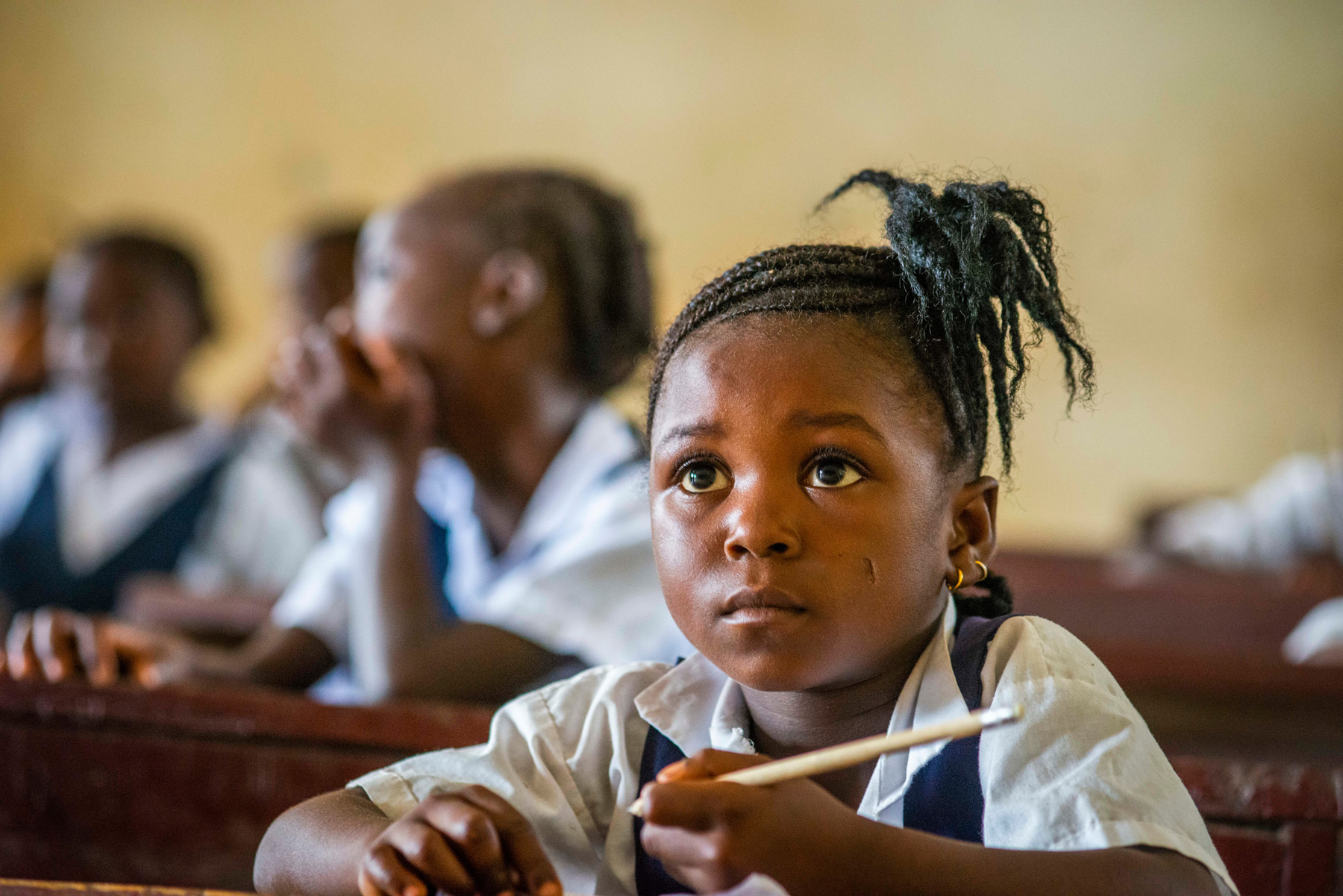 A girl concentrates during a lesson
