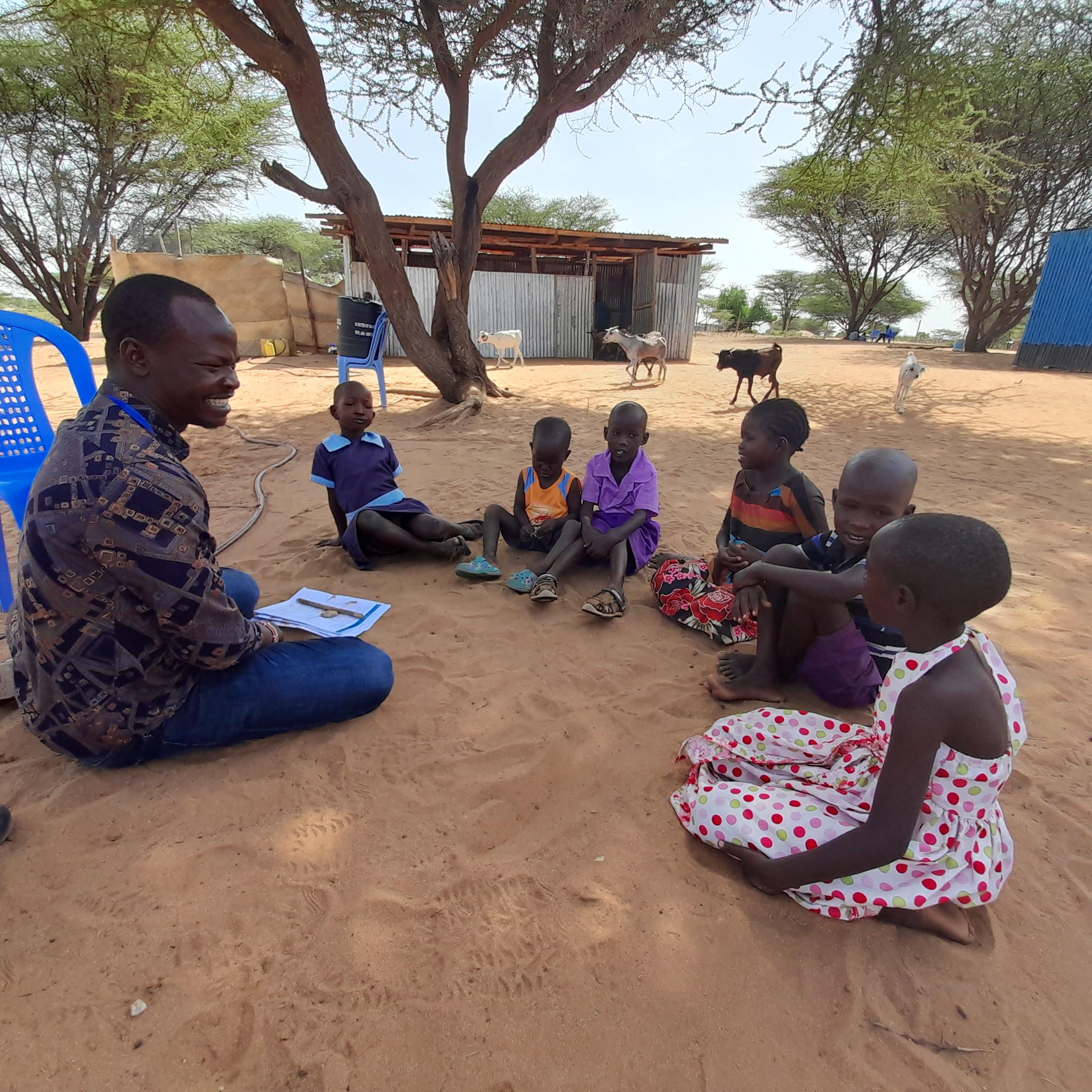 children sitting listening attentively 
