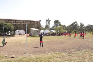 Children and young men playing football in Ethiopia