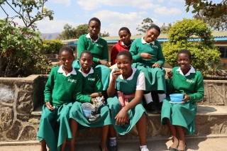 a group of class mates posing for a photo outdoors