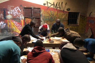 children drawing at desks in class