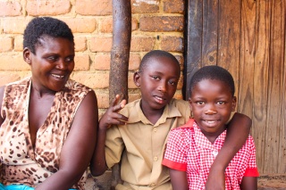 Mother smiling as her two children look into camera. 