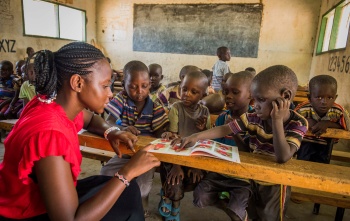 children in class listening attentively to their teacher