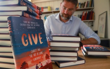 Magnus MacFarlane-Barrow, founder of Mary's Meals signing copies of his book, GIVE.