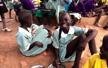 A girl laughs with her friends in South Sudan