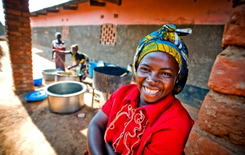 A volunteer cook in Zambia smiles