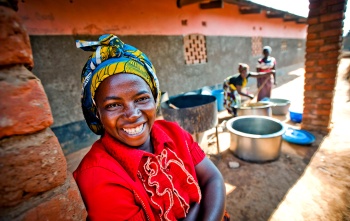 A volunteer cook in Zambia smiles
