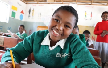 young girl in class smiling for the camera