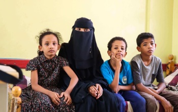 woman sitting with her children
