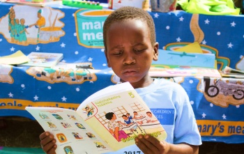 A young boy reads a book