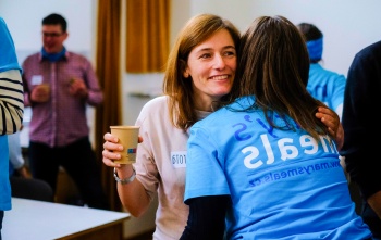 Two volunteers embrace at a Mary's Meals event