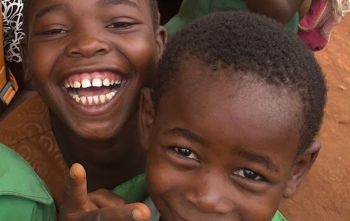 School children smiling and looking into camera
