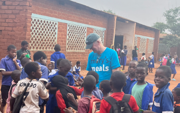 Arthur Coary meeting school children.