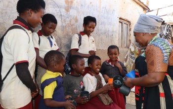 Vumiliya preparing her children for school.