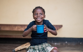 Boy eating Mary's Meals