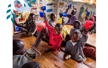 Children holding mugs up in the classroom