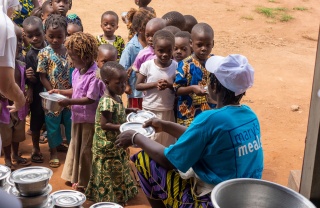 Children being served food in Benin