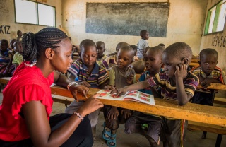 children in class listening attentively to their teacher