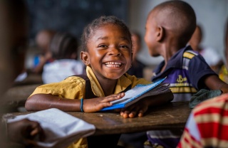 A Liberian school child learning in class.