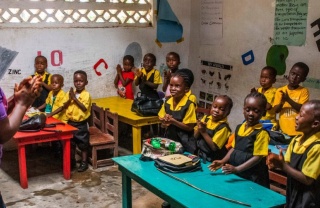 A classroom of children enjoying a lesson being taught by their teacher in a school in Liberia. 