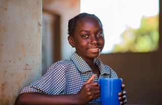 A girl with a mug of porridge