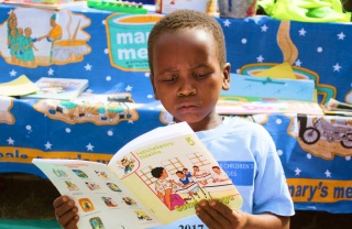 A young boy reads a book