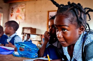 A determined girl takes notes in class