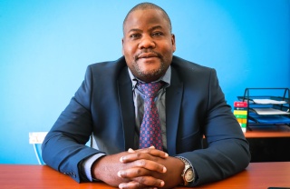 Panji Kajani, Country Director for Zambia and Zimbabwe, sitting at their desk. 