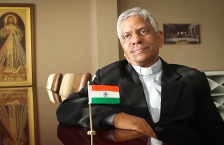 Director of BREAD, Father Josun, sitting down for an interview in his office.