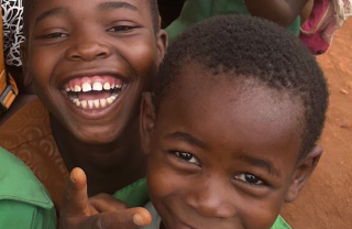 School children smiling and looking into camera
