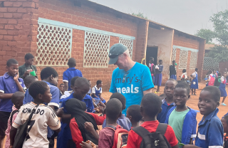 Arthur Coary meeting school children.