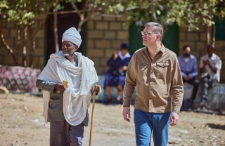 Magnus MacFarlane Barrow walking with a community elder in Tigray, Ethiopia.