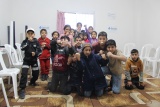 large group of children striking poses for a photo