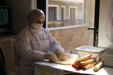 woman preparing wrapped food