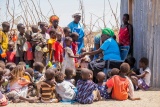 a volunteer serves food to children in Turkana