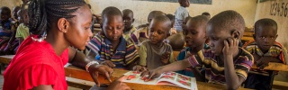 children in class listening attentively to their teacher