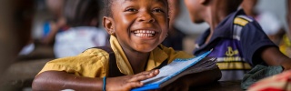A Liberian school child learning in class.