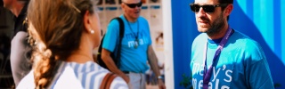 Two Mary's Meals supporters talking to each other outside the Mary's Meals information centre in Medjugorje.