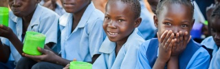 Children at school eating Mary's Meals.