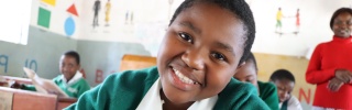 young girl in class smiling for the camera