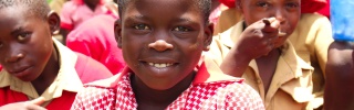 School children smiling and looking into camera