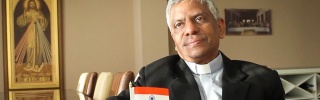Director of BREAD, Father Josun, sitting down for an interview in his office.