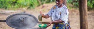 A volunteer prepares food