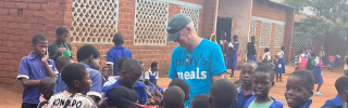 Arthur Coary meeting school children.