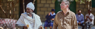 Magnus MacFarlane Barrow walking with a community elder in Tigray, Ethiopia.