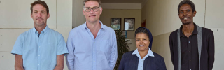 Gebrisha standing with Alex Keay & Magnus MacFarlane-Barrow of Mary's Meals, as well as Sister Medhin from our partner Daughters of Charity in Ethiopia.