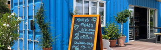 Image of the chalkboard outside of the blue container visitor centre for Mary's Meals in Medjugorje.