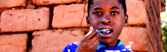 A boy enjoys food from Mary's Meals