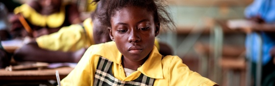 Girl reads in a classroom